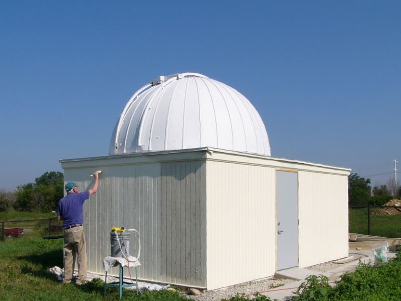 A member painting the refurbished Riley Observatory under its white dome