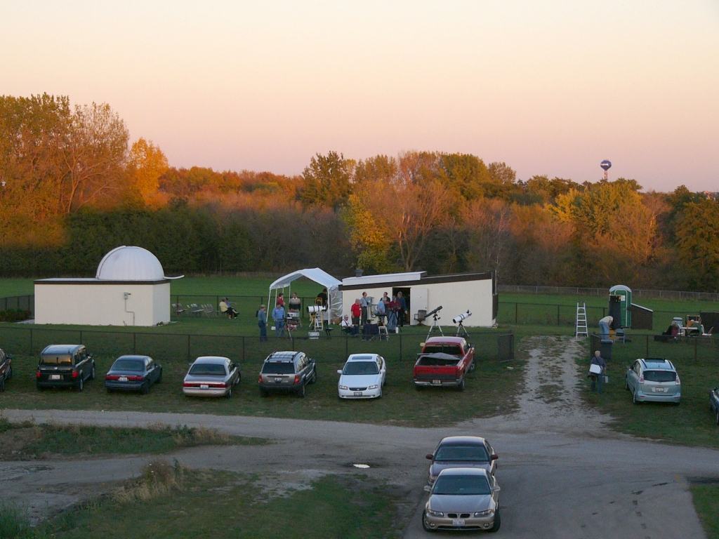 Members and guests with telescopes on the lawn at sunset, the domed Riley Observatory on the left and the DuPage Valley Observatory on the right